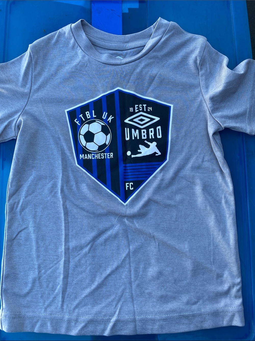 Umbro Light Gray Kids Soccer Shield Tee with Blue Graphic
